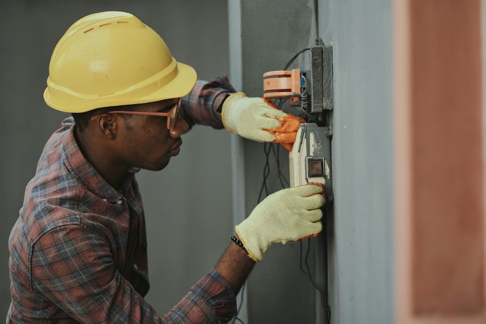An electrical professional carefully working on an installation
